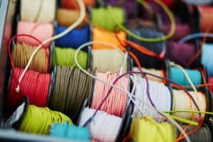 Variety of spools with rope of different colors for sewing or crafting on a market